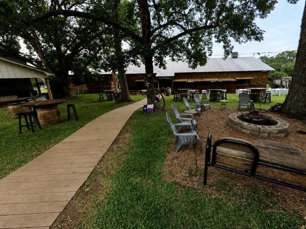 Fire pit and chairs under the oaks