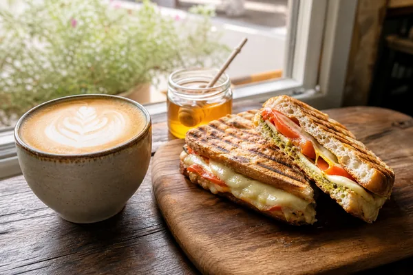 Latte and a panini in a bright cafe