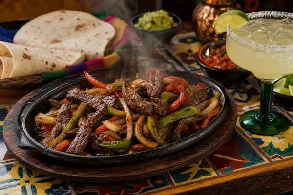 Sizzling fajitas and a margarita