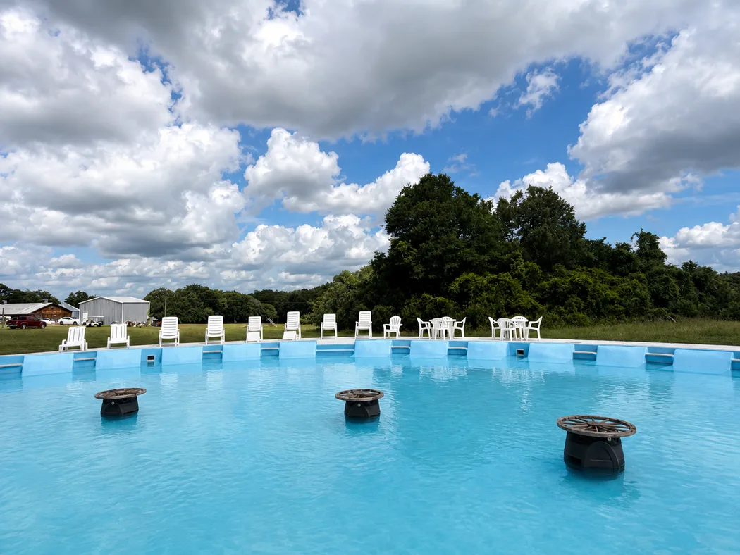 The water tank pool with loungers along the far edge